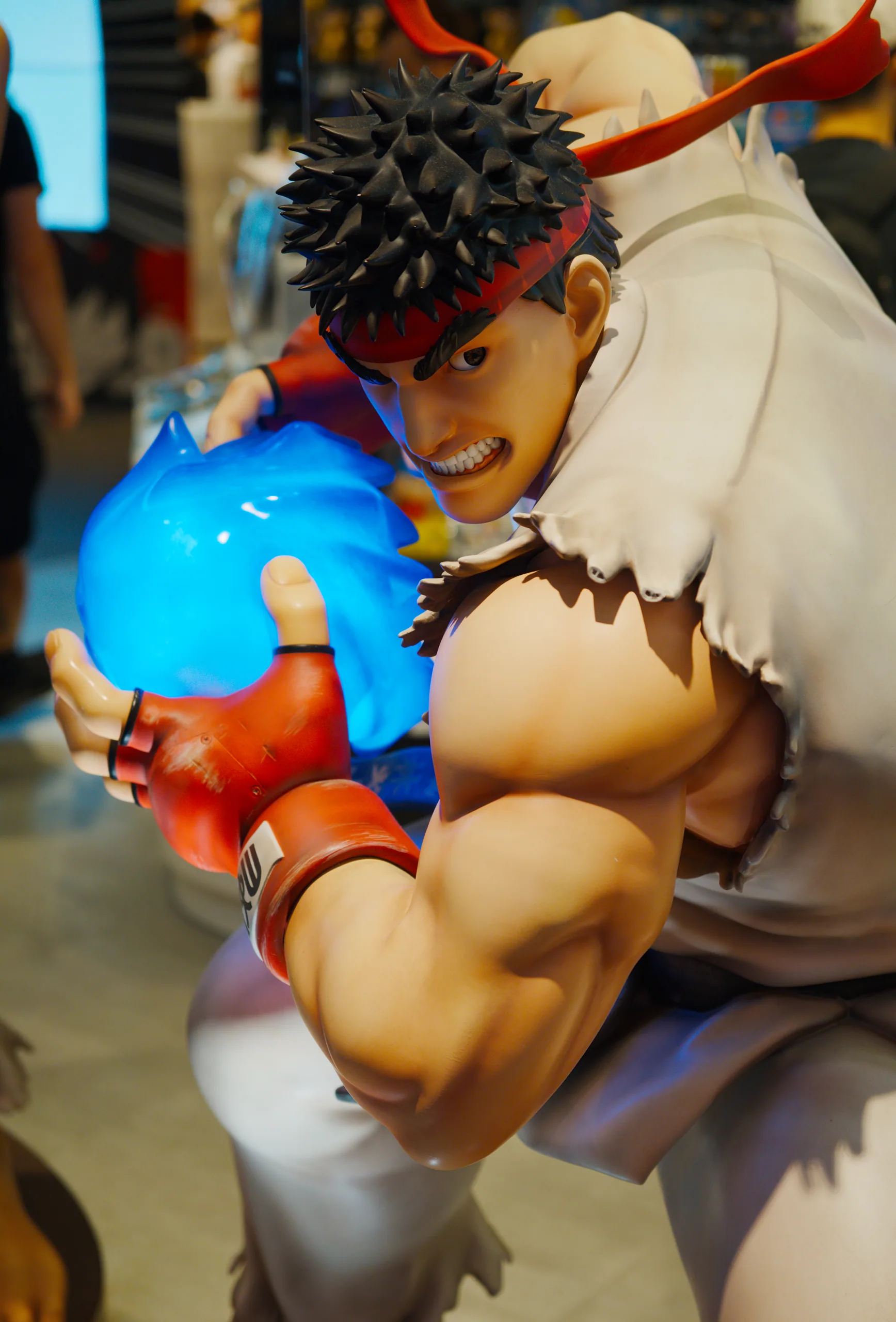 Bowser character figurine with spiky hair and shell details on display in an indoor space.