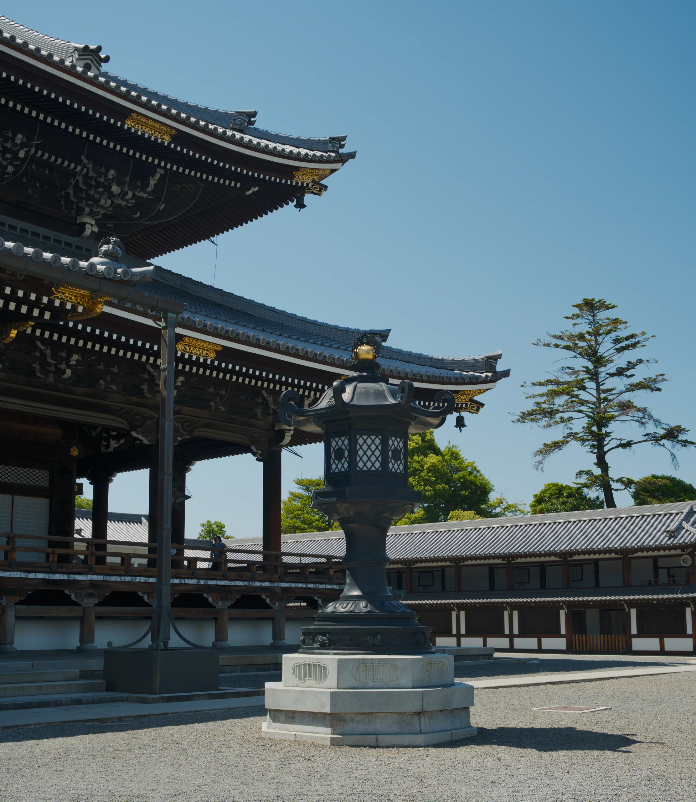 Ornate upturned temple roof eaves with gilt details and carved wooden structural beams.