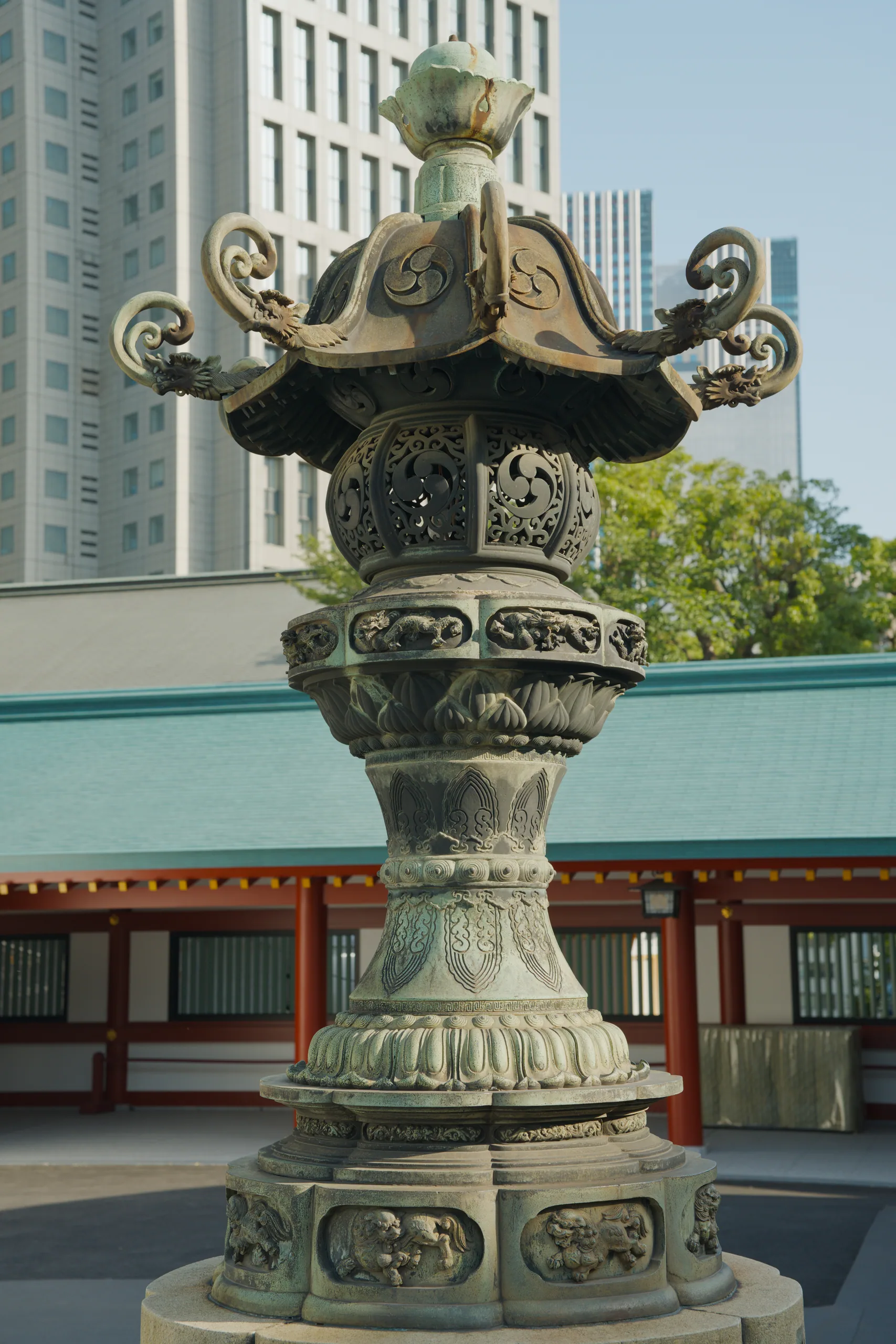 An elaborately carved stone pedestal with ornamental dragon figures at its crown.
