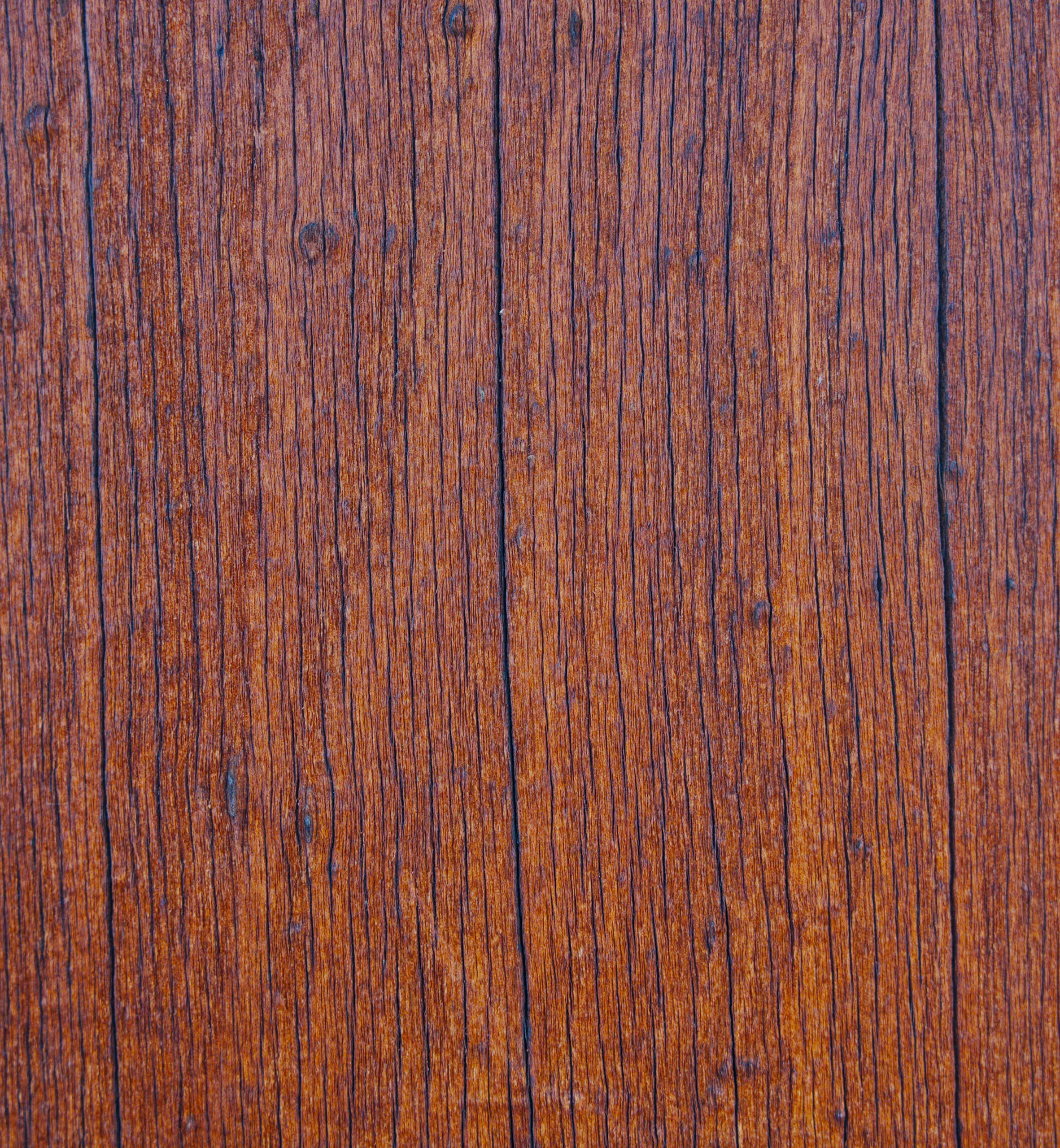 Weathered wooden planks with deep grain patterns and knots.