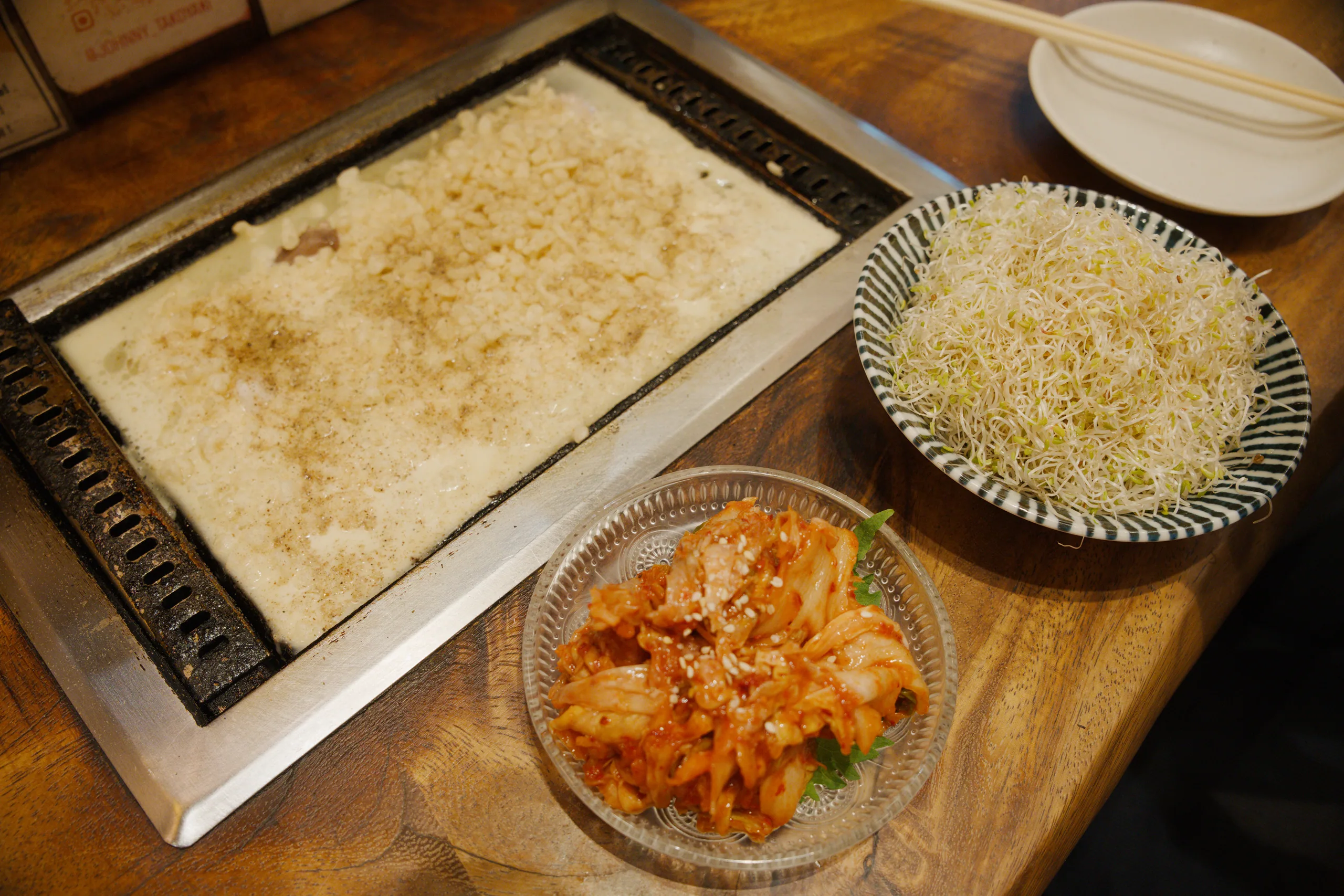 Multiple prepared dishes including rice, roasted vegetables, and a casserole arranged on a wooden counter.