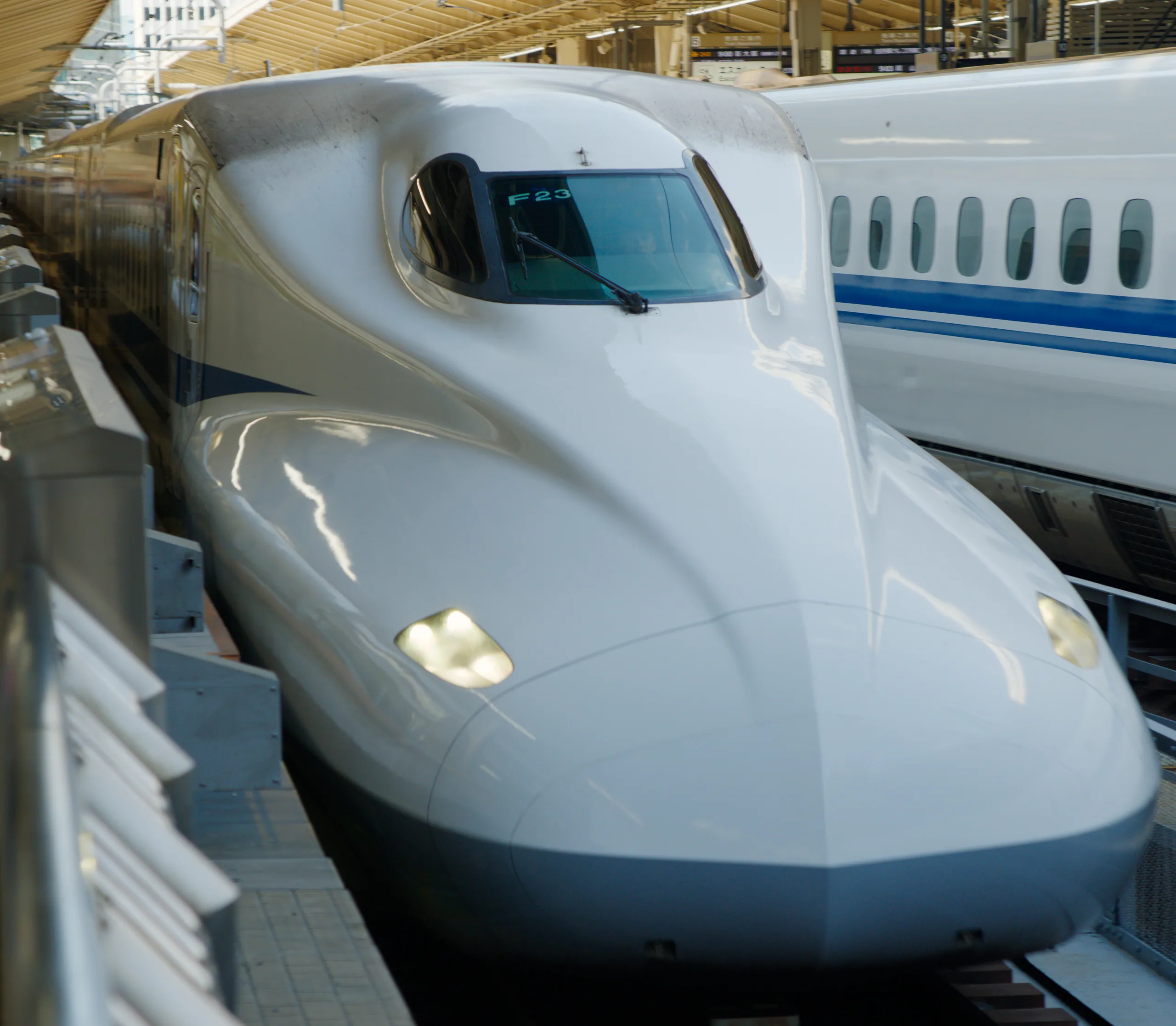 White shinkansen nose at a station platform.