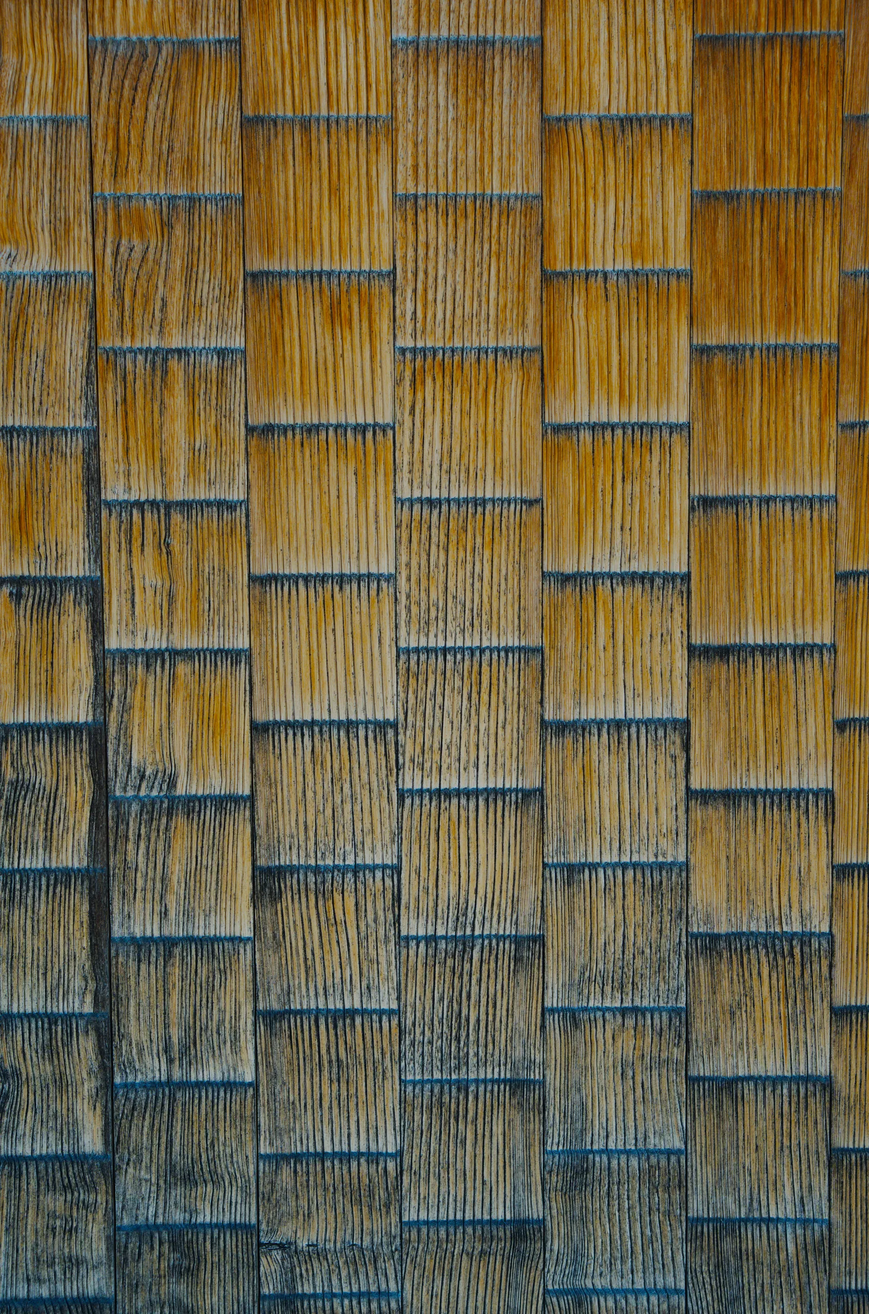 Woven pattern in gold and blue creating a crossed-rectangle grid.