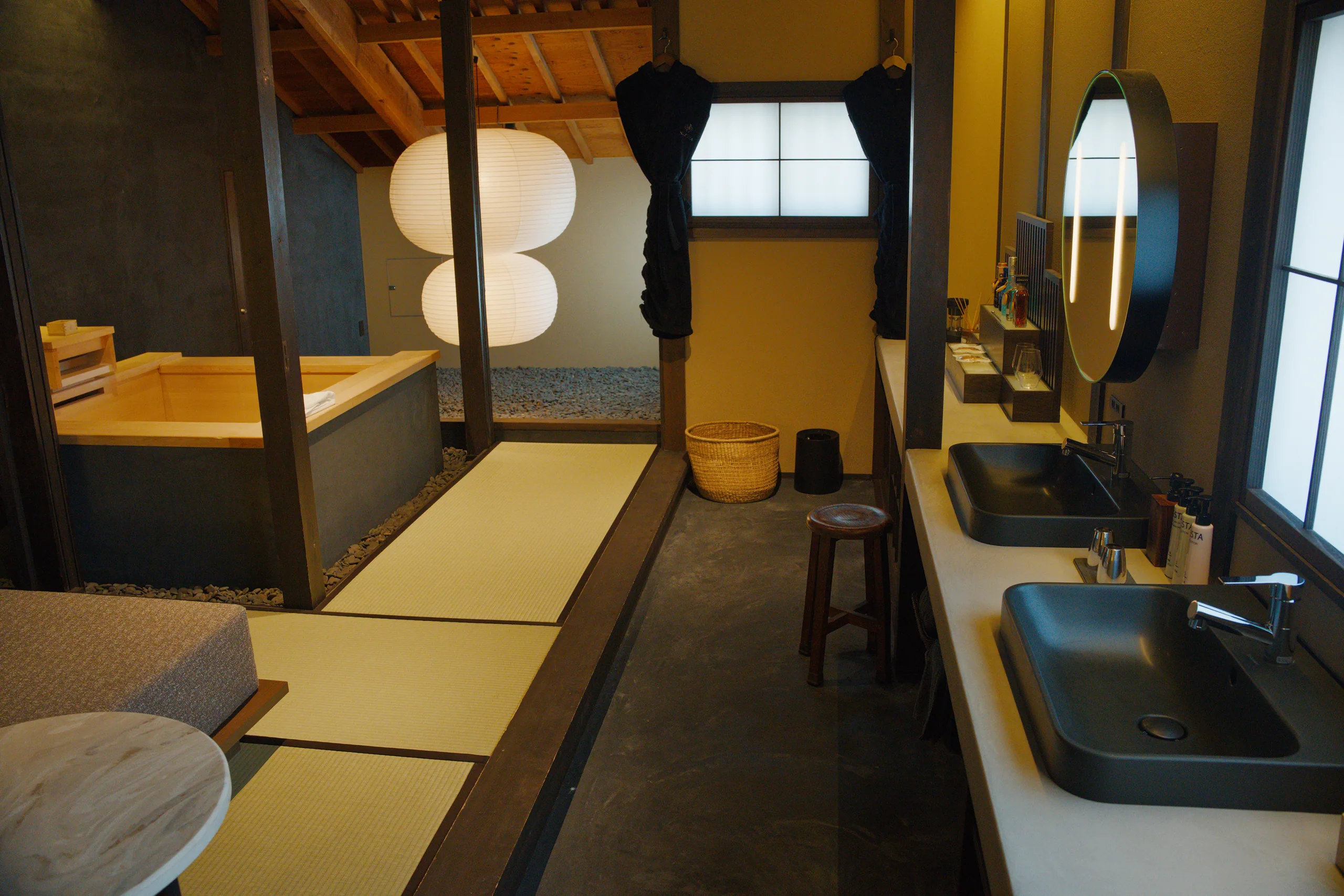 Polished hotel corridor with glazed partitions and warm golden lighting.