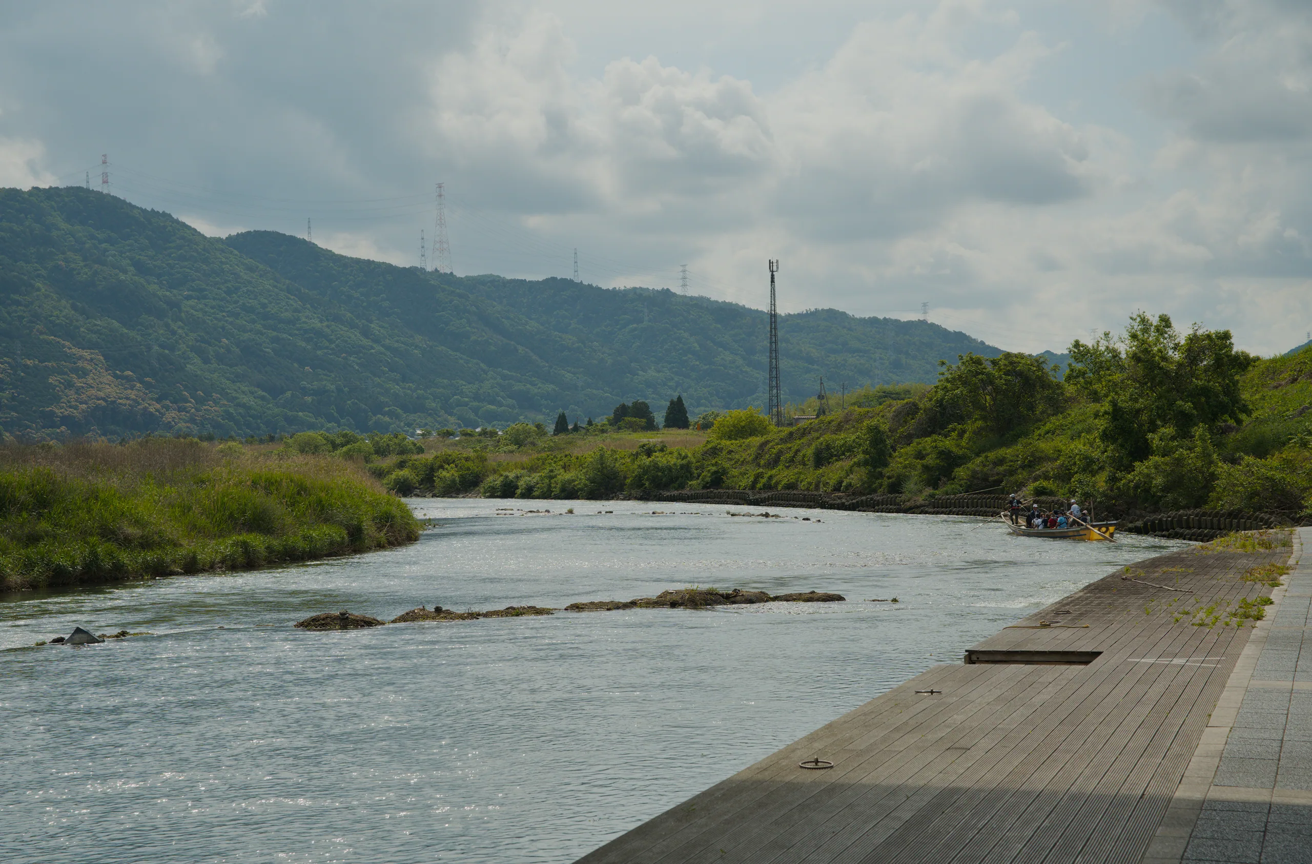 A river curves through a mountain valley with green vegetation lining both banks.