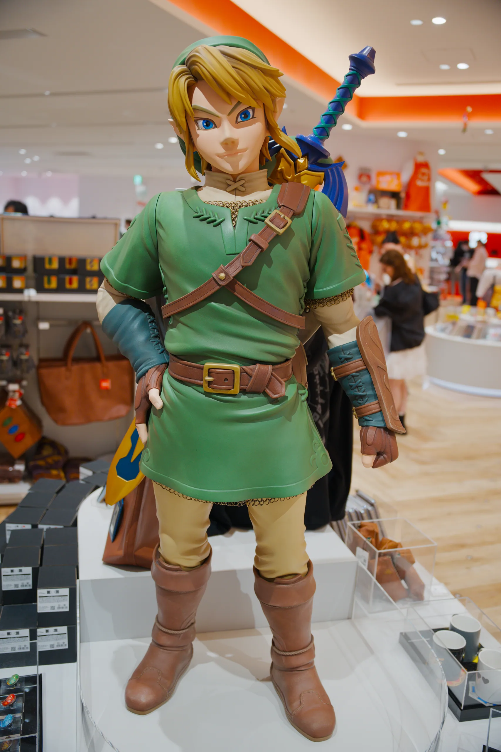 Link character figurine in green tunic holding a sword and bow, displayed indoors.