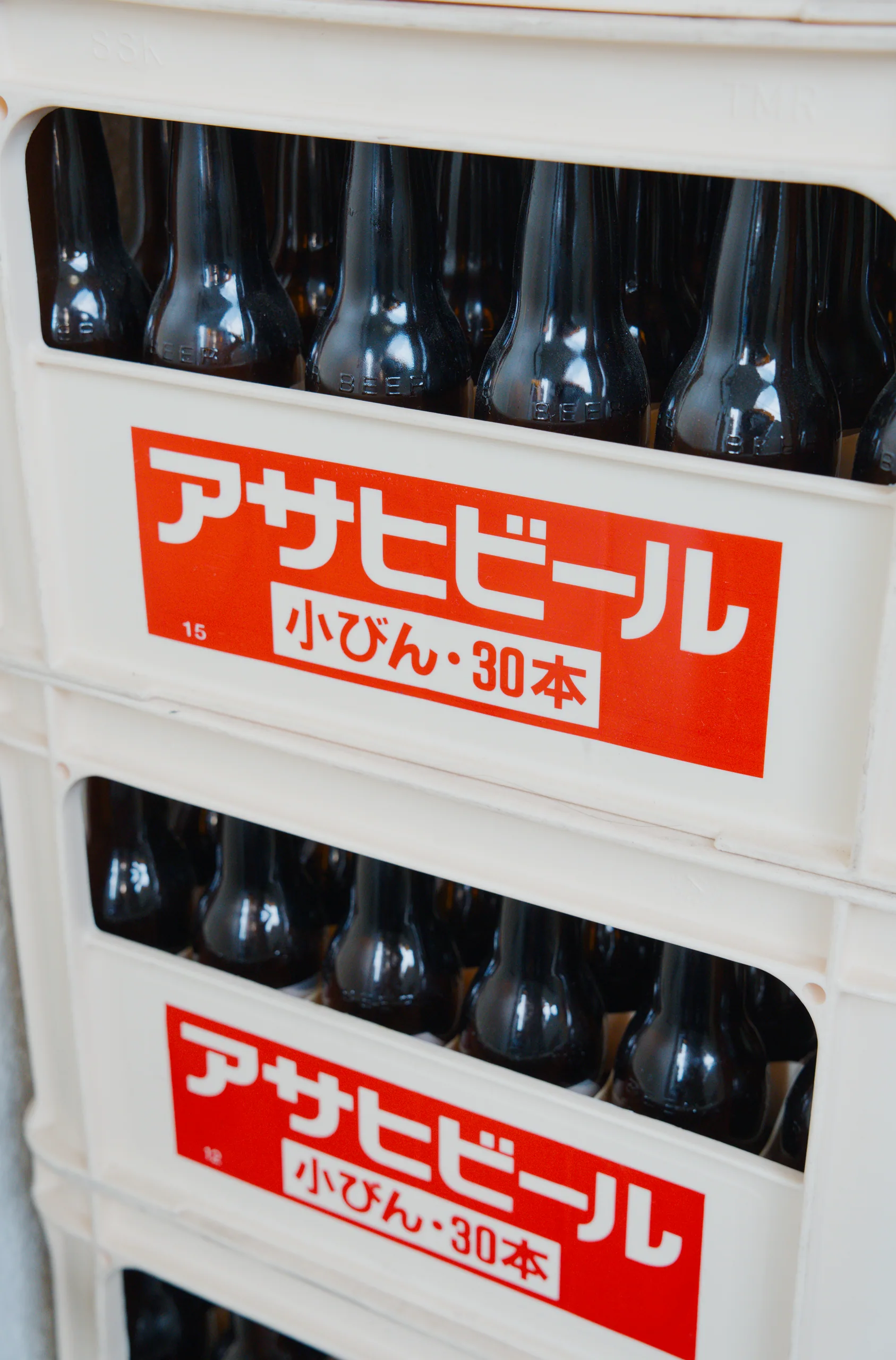 A chilled beer display box stacked with bottles bearing Asahi branding.