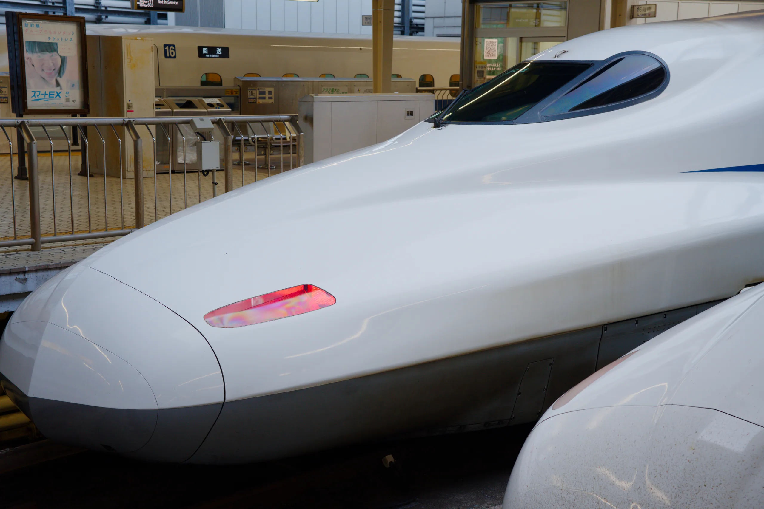 Shinkansen nose profile with red light.