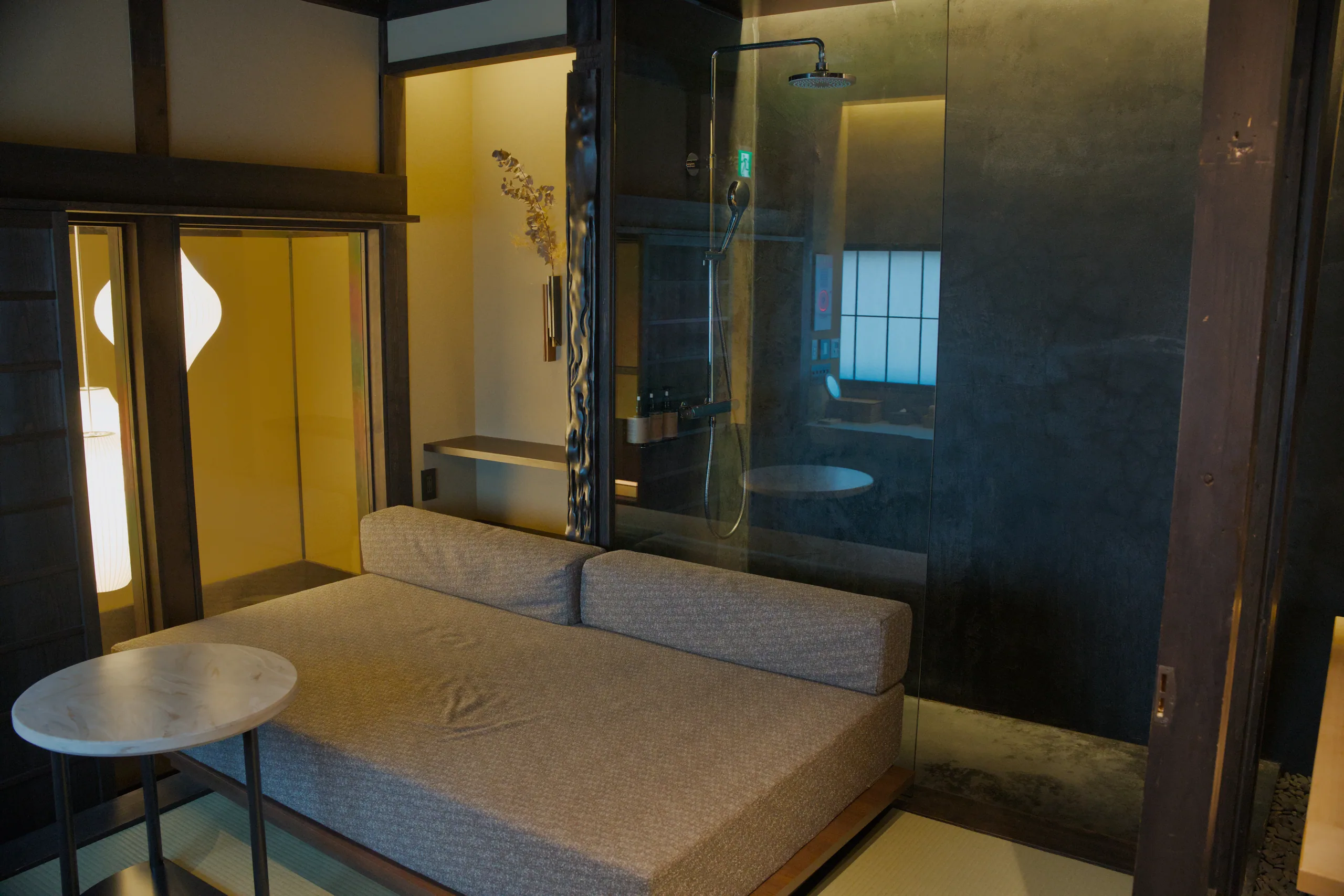 Modern hotel lobby with tan seating, floor-to-ceiling windows, and minimalist design.
